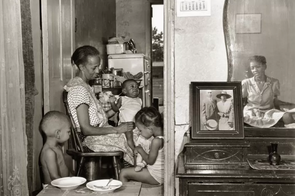 Mrs. Ella Watson, a government charwoman, with three grandchildren and her adopted daughter